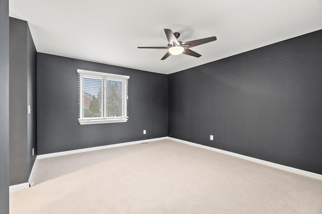 empty room with carpet, baseboards, and ceiling fan