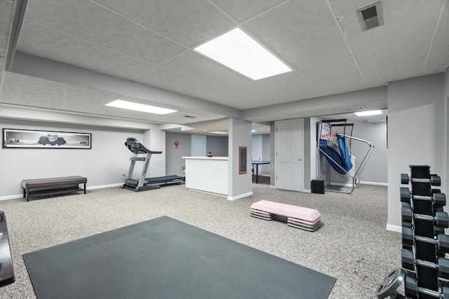 exercise area with baseboards, carpet, visible vents, and a drop ceiling