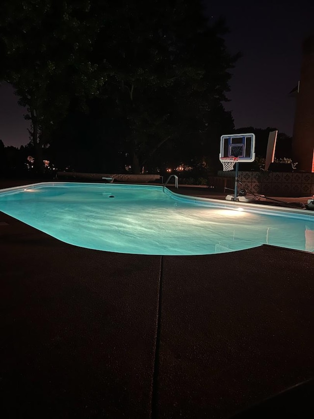 pool at night with an outdoor pool