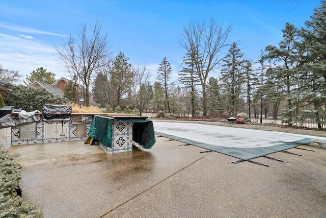 view of swimming pool with a fenced in pool, a patio area, fence, and a diving board