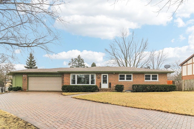 ranch-style house featuring a garage, decorative driveway, brick siding, and a front lawn