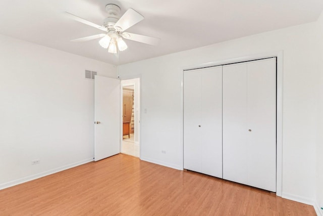 unfurnished bedroom with light wood-style floors, a closet, visible vents, and baseboards