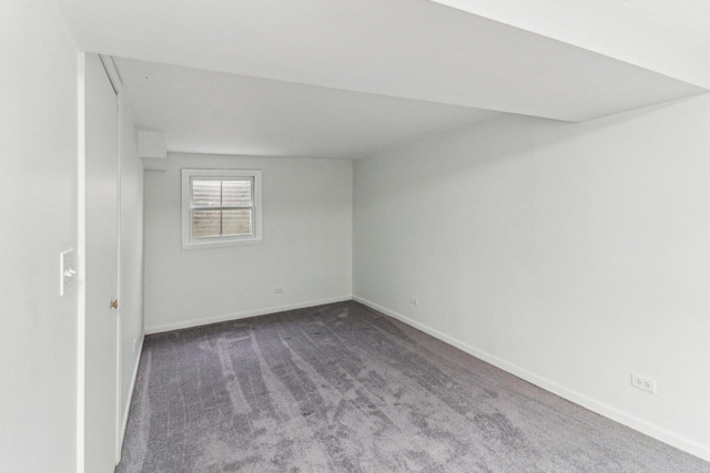 carpeted spare room with baseboards