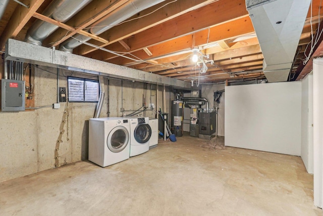 below grade area with gas water heater, washing machine and clothes dryer, electric panel, and heating unit