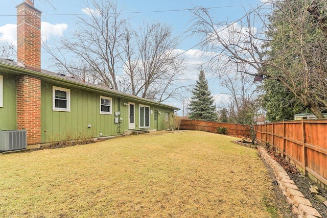 view of yard featuring central air condition unit and a fenced backyard