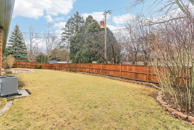 view of yard with a fenced backyard and central air condition unit