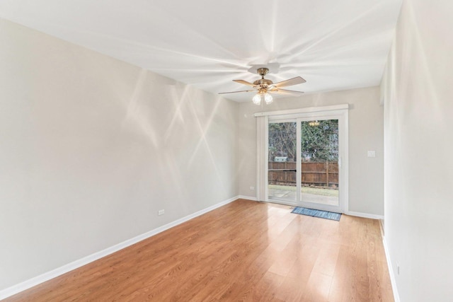 empty room featuring a ceiling fan, light wood-style flooring, and baseboards