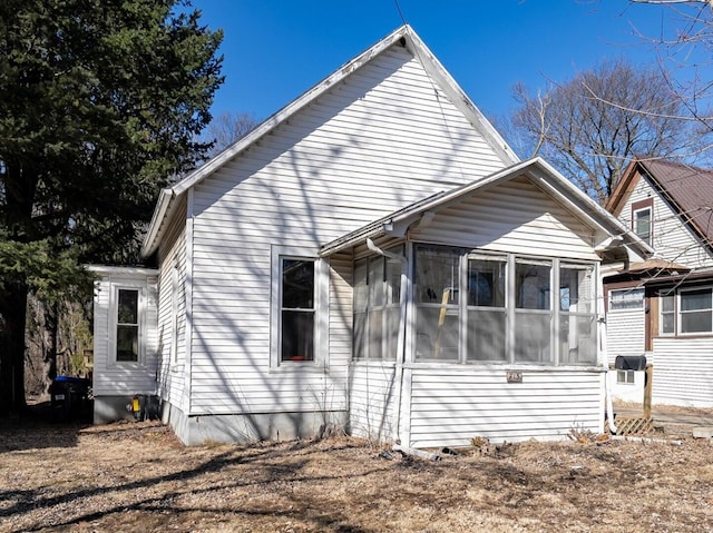 view of side of property featuring a sunroom