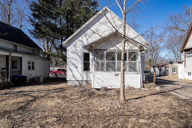 exterior space with a sunroom and central AC