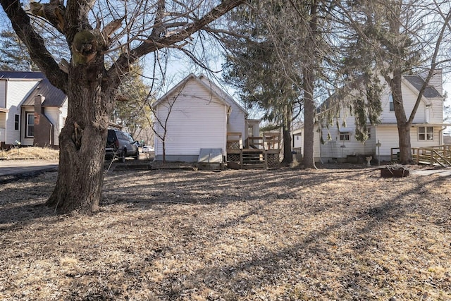 view of property exterior with a wooden deck