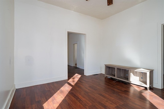 unfurnished room with baseboards and wood finished floors