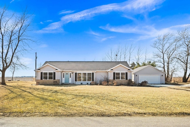 single story home featuring an outbuilding, a detached garage, and a front yard