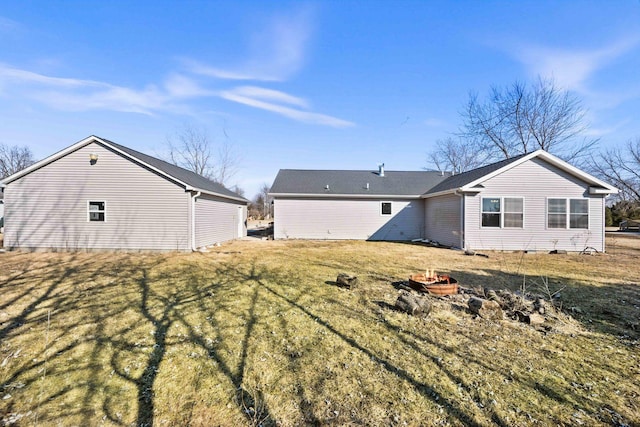 rear view of property featuring an outdoor fire pit