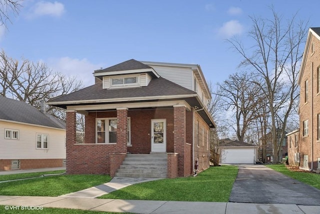 bungalow featuring a garage, a porch, an outbuilding, a front lawn, and brick siding