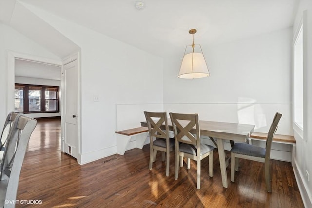 dining room featuring visible vents, baseboards, and wood finished floors