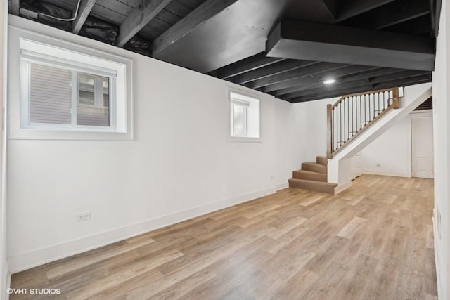 basement with baseboards, stairway, and wood finished floors