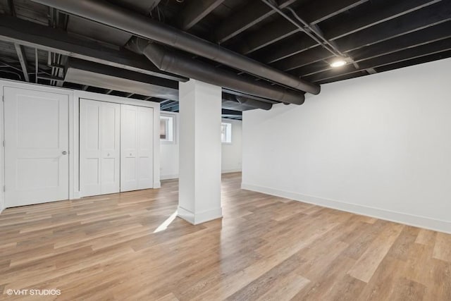 basement with light wood-style floors and baseboards