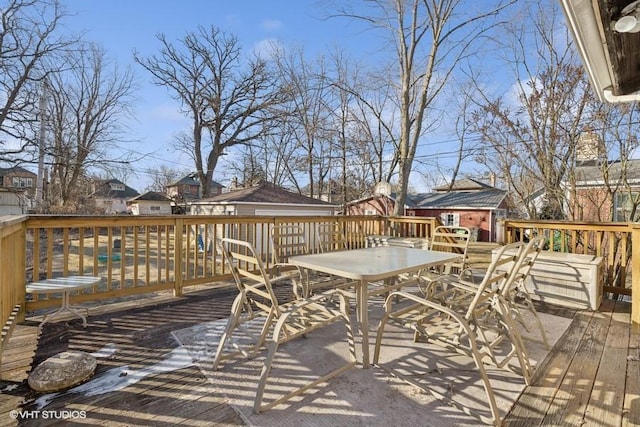 wooden deck featuring outdoor dining area