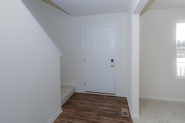 entrance foyer featuring baseboards, stairway, visible vents, and a healthy amount of sunlight