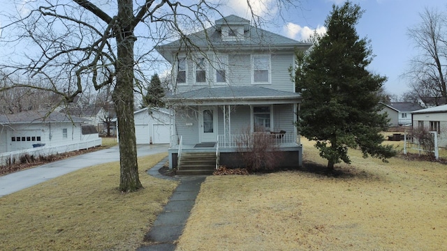 traditional style home with covered porch, roof with shingles, an outdoor structure, and a front yard