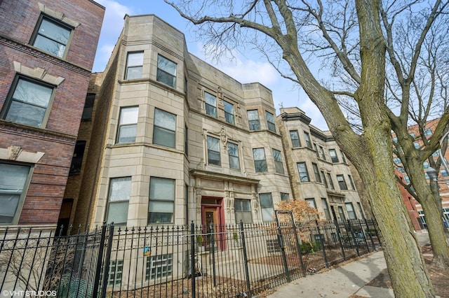 view of building exterior featuring a fenced front yard