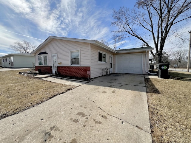 single story home with a garage, concrete driveway, and brick siding