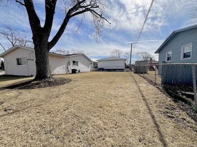 view of yard featuring driveway and fence