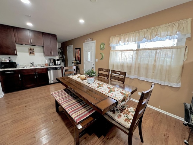 dining room with light wood-style floors, recessed lighting, and baseboards