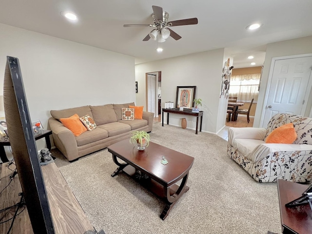 carpeted living room featuring baseboards, a ceiling fan, and recessed lighting