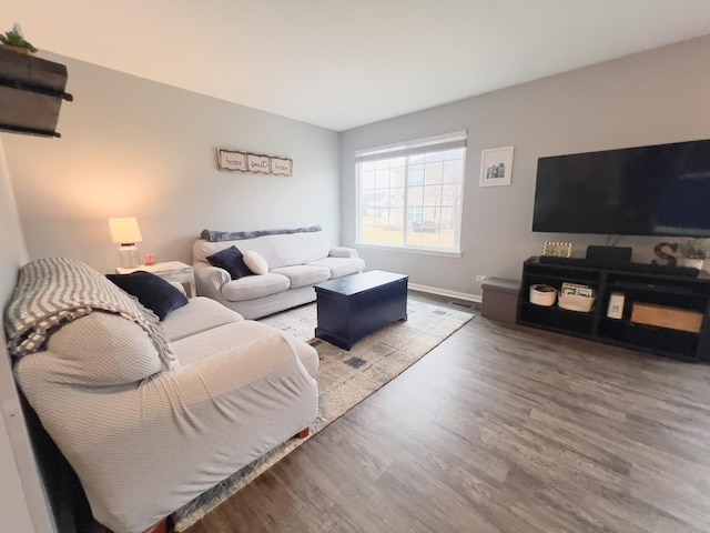 living room featuring baseboards and wood finished floors