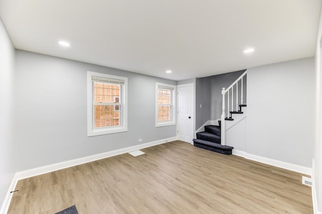 interior space with stairs, baseboards, wood finished floors, and recessed lighting