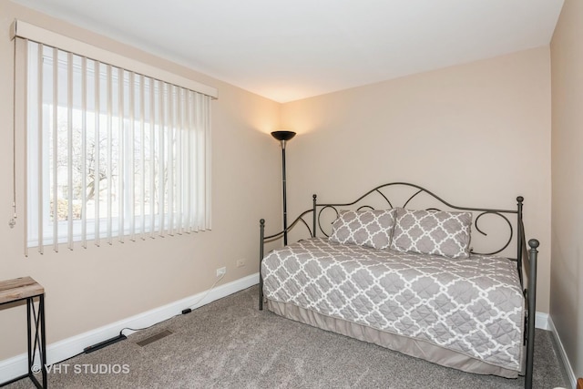 carpeted bedroom featuring visible vents and baseboards