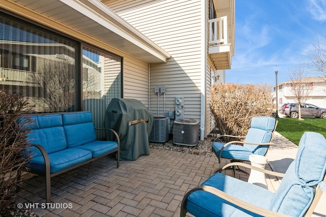 view of patio / terrace with grilling area, a balcony, and central AC