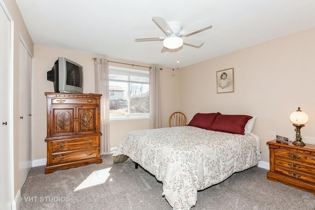 carpeted bedroom with a closet, ceiling fan, and baseboards