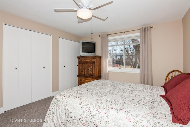 bedroom with multiple closets, a ceiling fan, and carpet flooring