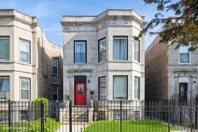 4904 W Fulton St, Chicago, IL 60644 - view of front of house with stone siding and a fenced front yard