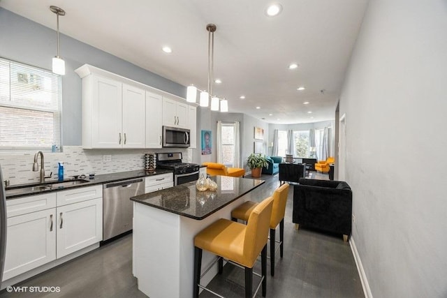 4904 W Fulton St, Chicago, IL 60644 - kitchen with appliances with stainless steel finishes, open floor plan, recessed lighting, a sink, and a center island