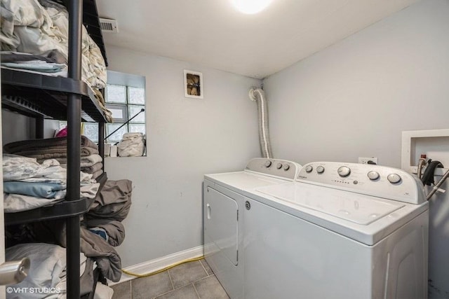 4904 W Fulton St, Chicago, IL 60644 - laundry room featuring washing machine and dryer, baseboards, and tile patterned flooring