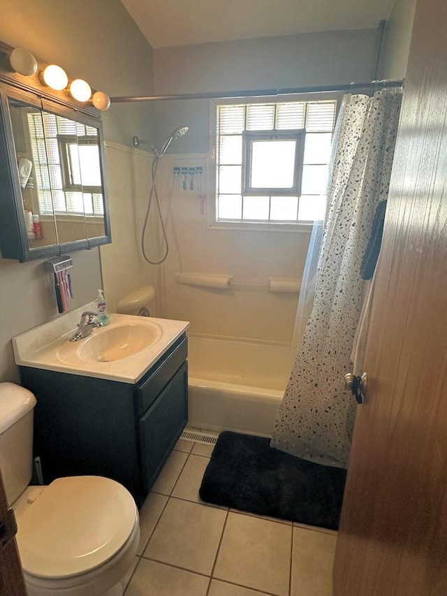 full bath featuring toilet, tile patterned flooring, shower / bath combo with shower curtain, and vanity