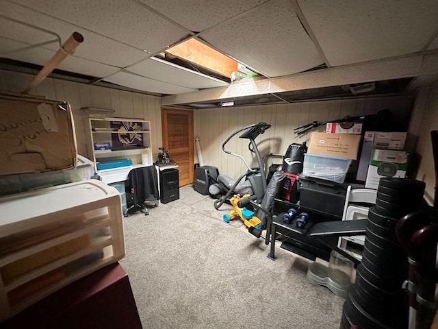 exercise room with carpet and a paneled ceiling