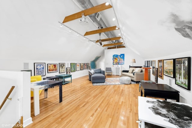 playroom featuring lofted ceiling with beams, light wood finished floors, and track lighting