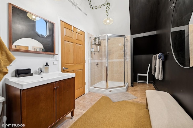 bathroom with a stall shower, vanity, and tile patterned floors