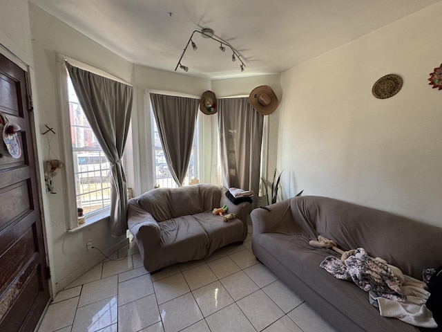 living room featuring light tile patterned floors and rail lighting