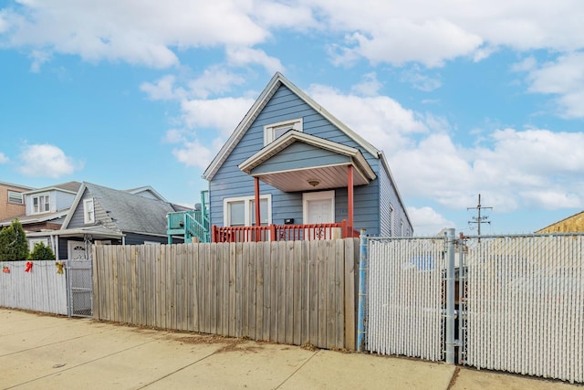 view of front of property featuring a fenced front yard and a gate