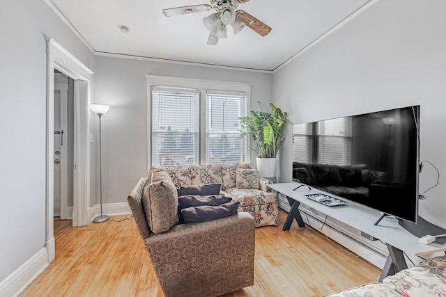 living room featuring ornamental molding, baseboards, ceiling fan, and hardwood / wood-style floors