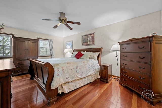 bedroom with dark wood-style floors and ceiling fan