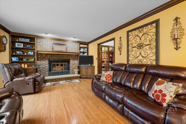 living area featuring a brick fireplace, crown molding, and wood finished floors