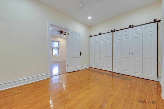 interior space featuring light wood finished floors, ceiling fan, baseboards, and recessed lighting