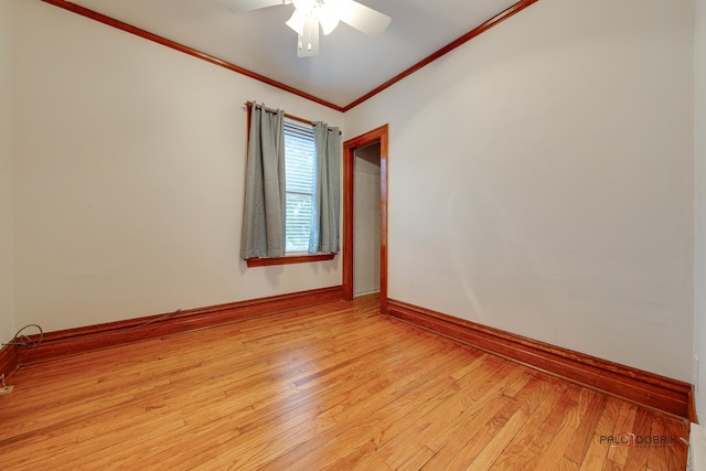 unfurnished room with light wood-style floors, crown molding, baseboards, and ceiling fan