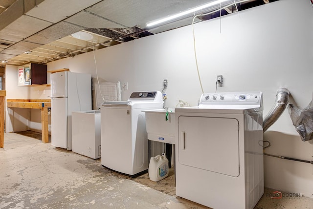 washroom with washing machine and dryer and laundry area